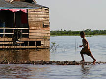 Boy at play in the floating villages of the Tonle Sap, Siem Reap, Cambodia